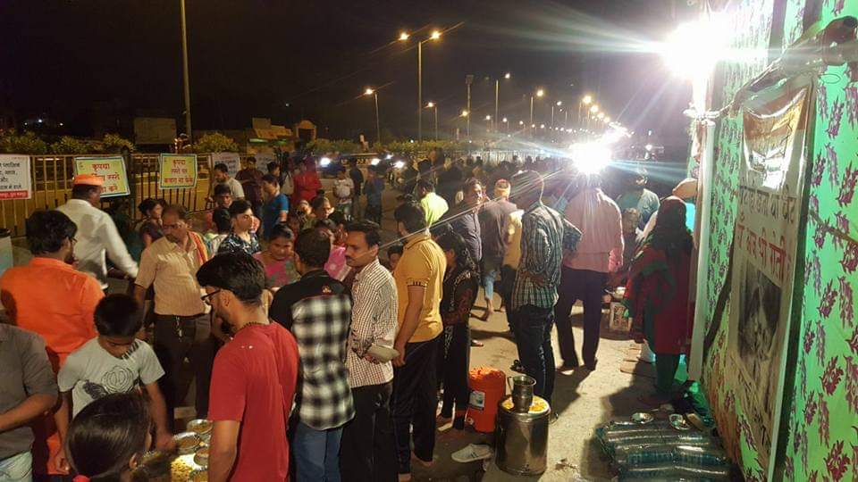 People waiting in line for evening food seva